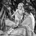 A family enjoying a playful outdoor moment in a forest setting.